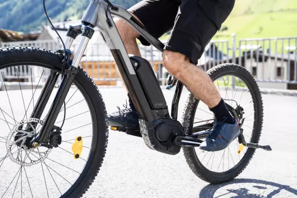 Man Riding E Bike Bicycle In City. Electric Bike In Summer